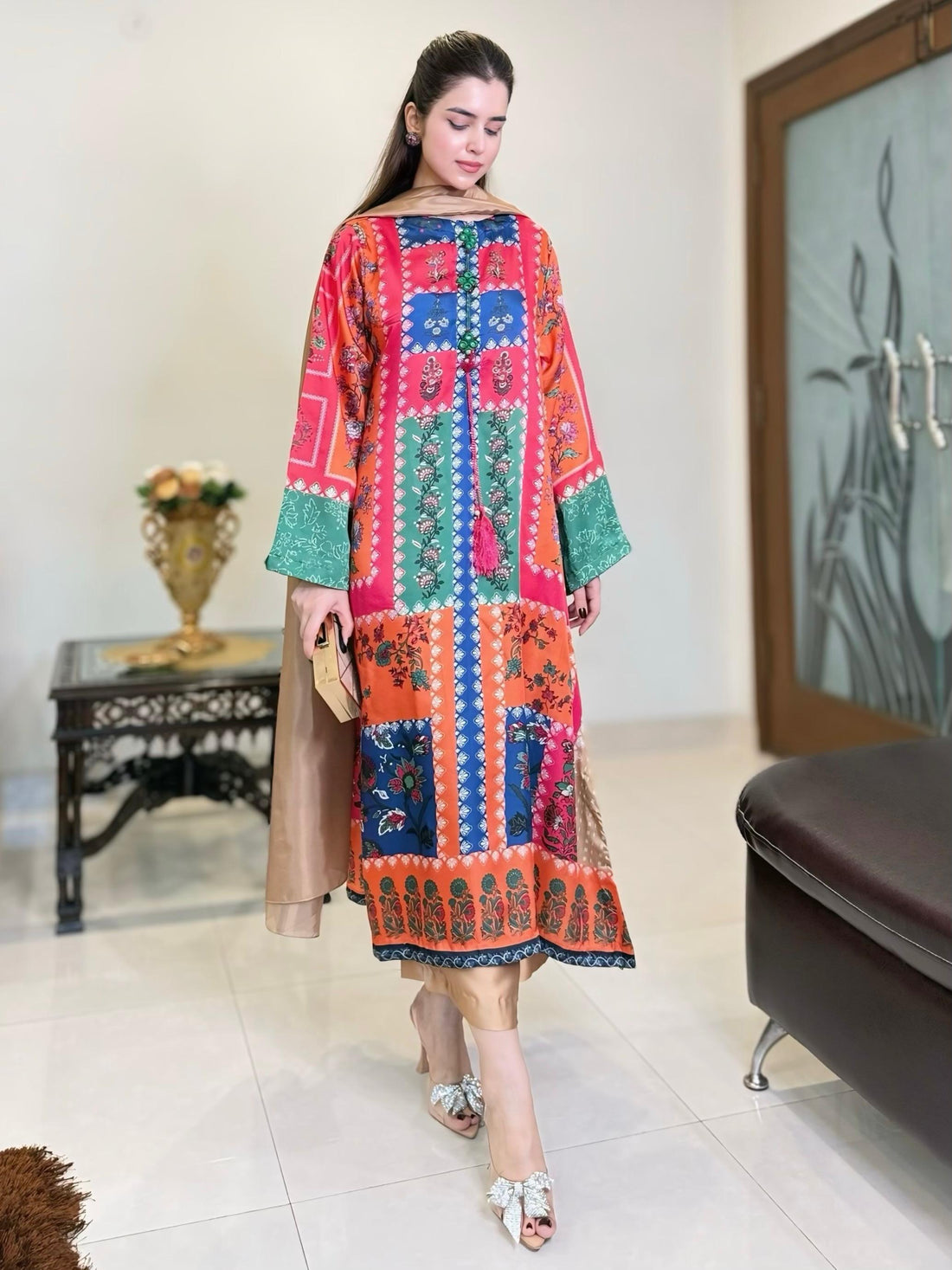 Model wearing a vibrant high-quality Pakistani silk suit showcasing premium fabric, rich colours, and detailed craftsmanship.