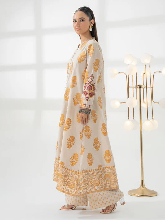 Woman wearing a traditional outfit with yellow floral patterns in a minimalistic setting.