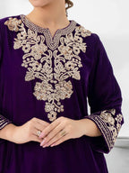 Woman wearing a purple velvet suit by limelight background white 