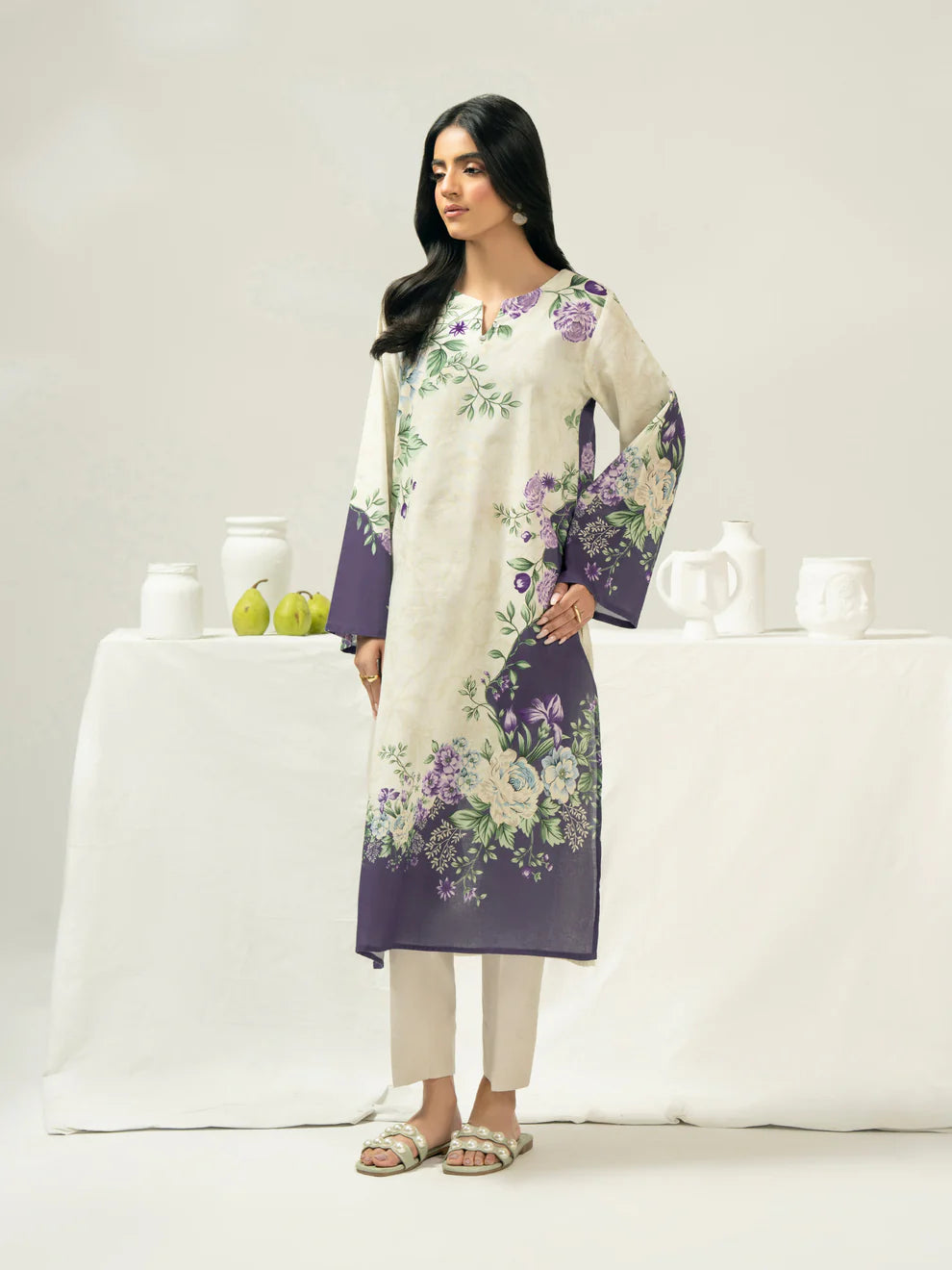 Woman wearing a floral dress with a white background