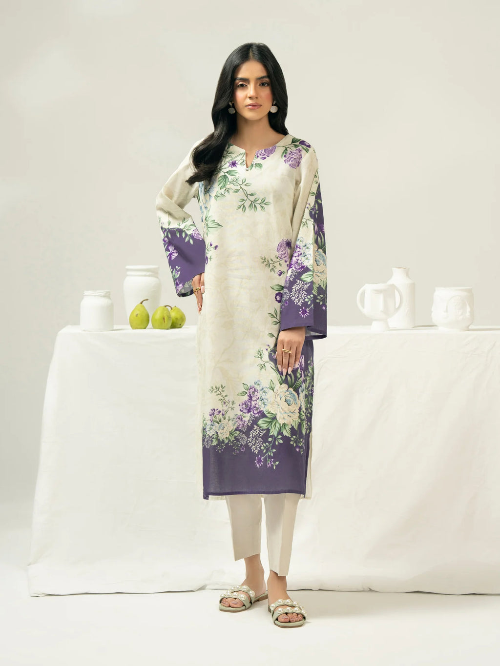 Woman wearing a floral kurta with a white background