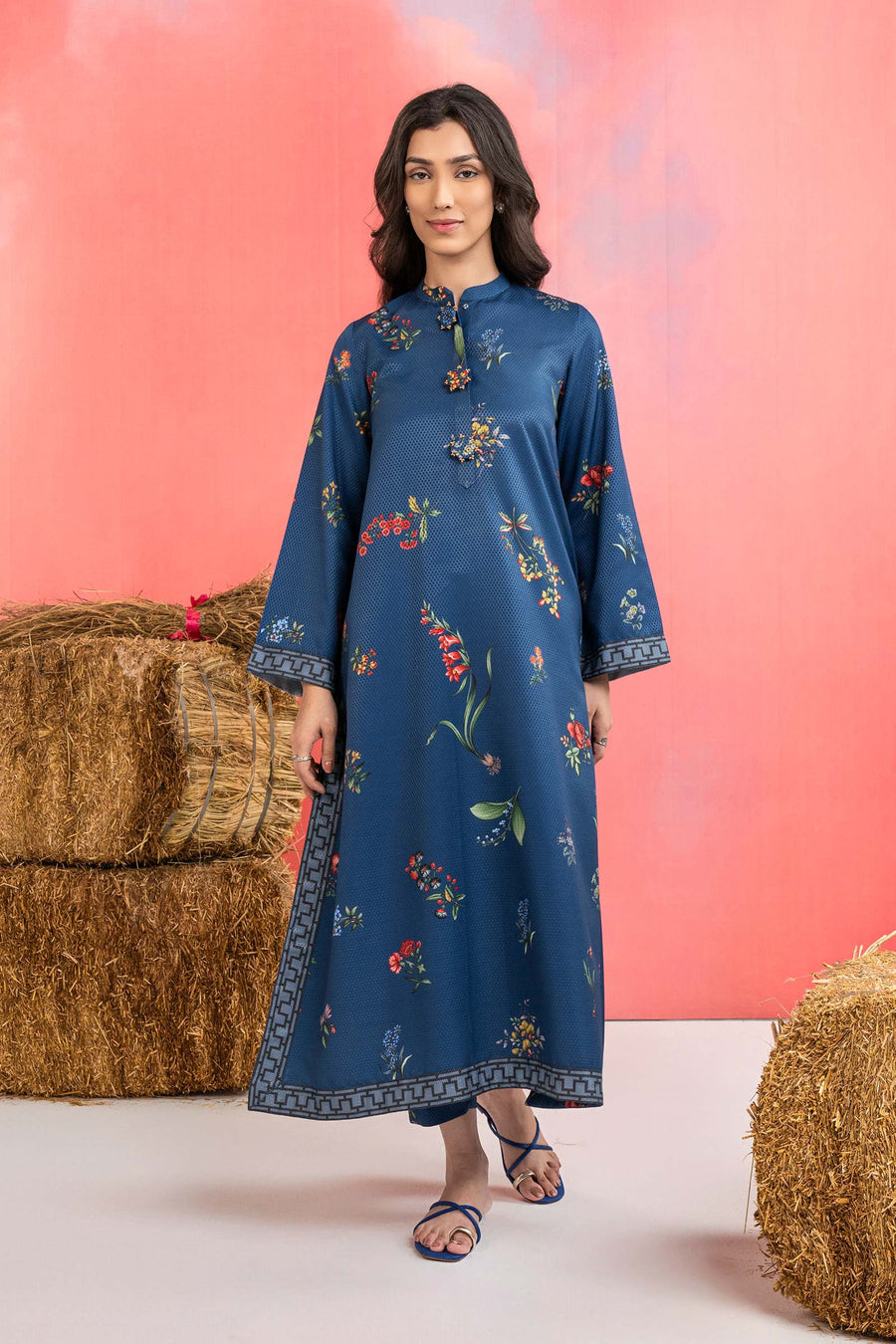 Woman wearing a maria b blue printed A-line dobby viscose shirt with floral patterns, band collar, wide sleeves, and matching straight trousers