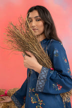 Woman wearing a maria b blue printed A-line dobby viscose shirt with floral patterns, band collar, wide sleeves, and matching straight trousers