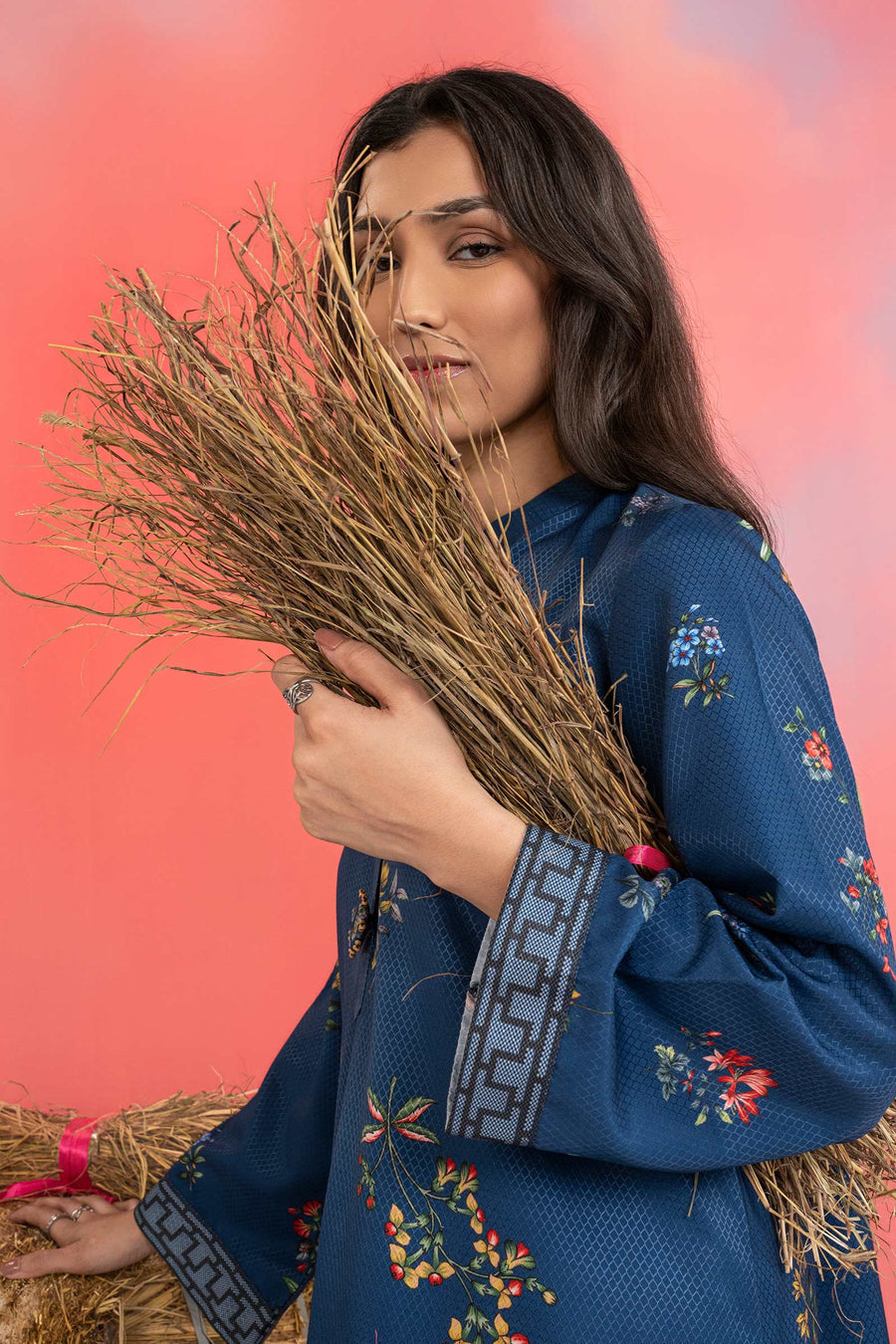 Woman wearing a maria b blue printed A-line dobby viscose shirt with floral patterns, band collar, wide sleeves, and matching straight trousers