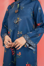 Woman wearing a maria b blue printed A-line dobby viscose shirt with floral patterns, band collar, wide sleeves, and matching straight trousers