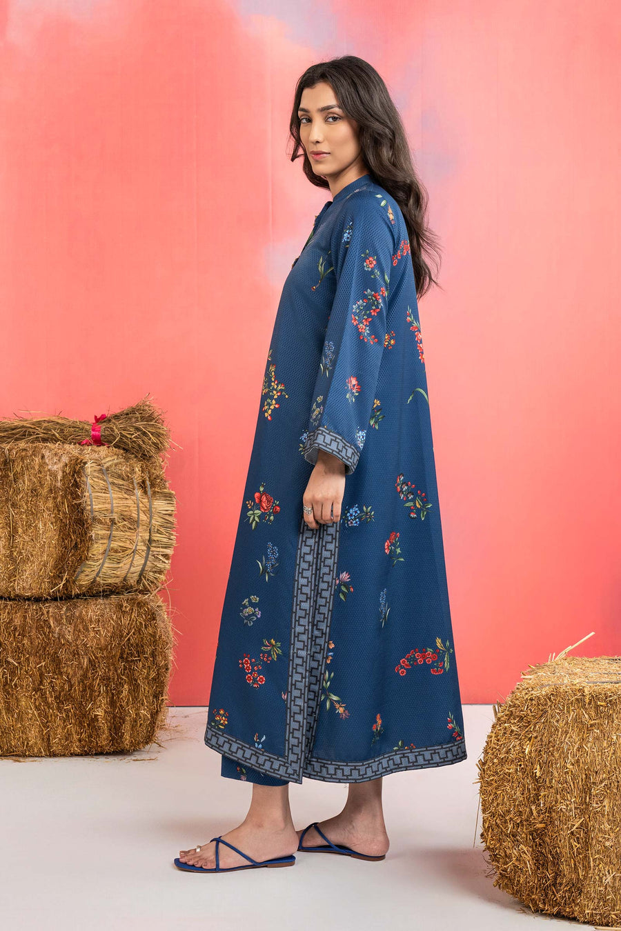 Woman wearing a maria b blue printed A-line dobby viscose shirt with floral patterns, band collar, wide sleeves, and matching straight trousers