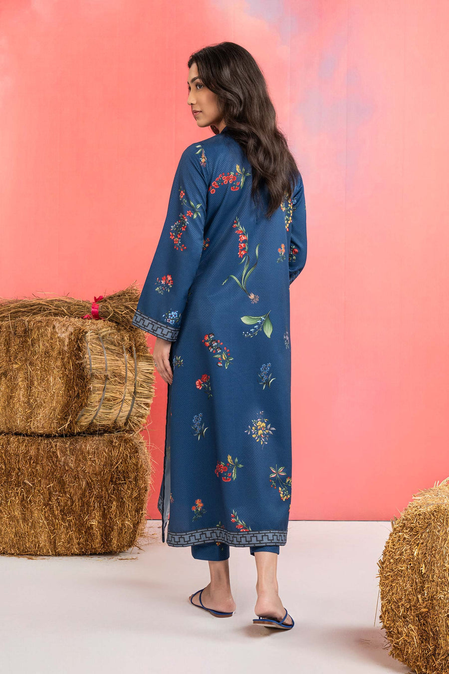 Woman wearing a maria b blue printed A-line dobby viscose shirt with floral patterns, band collar, wide sleeves, and matching straight trousers
